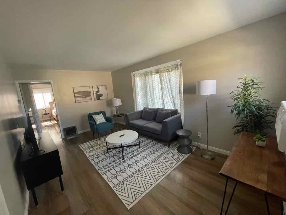 A living room left tidy and vacuumed after a recurring house clean
